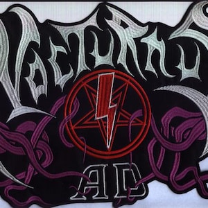 May include: Embroidered patch featuring the word "Nocturnal" in silver, a red pentagram with a lightning bolt, and the letters "AD" on a black background. The design includes purple tendrils and a white border.