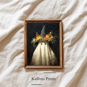 May include: A framed Halloween-themed print featuring a ghost wearing a witch's hat adorned with autumn leaves and flowers. The ghost is draped in a white sheet, with a dark background. The text "Kallisto Prints" is at the bottom.