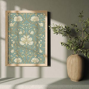 May include: A framed print of a vintage floral pattern with white flowers and green leaves on a blue background.