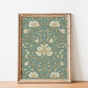 May include: A framed print with a vintage floral pattern. The design features white flowers with gold accents on a teal background.