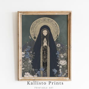 May include: A framed print featuring a religious figure in a dark blue cloak with hands clasped in prayer. The artwork has a gold halo and is surrounded by blue and white flowers. The frame is a light brown color. The text "Kallisto Prints Printable Art" is at the bottom.