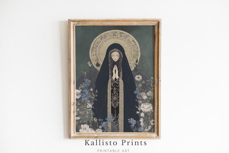 May include: A framed print featuring a religious figure in a dark blue cloak with hands clasped in prayer. The artwork has a gold halo and is surrounded by blue and white flowers. The frame is a light brown color. The text "Kallisto Prints Printable Art" is at the bottom.