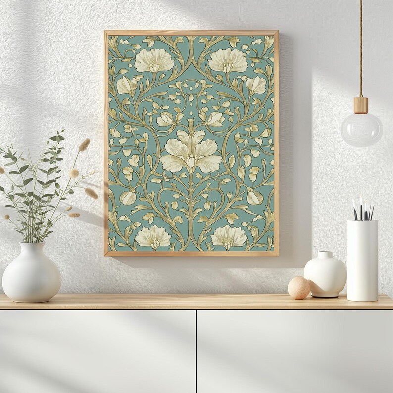 May include: A framed print of a vintage floral pattern with white flowers and gold vines on a teal background.