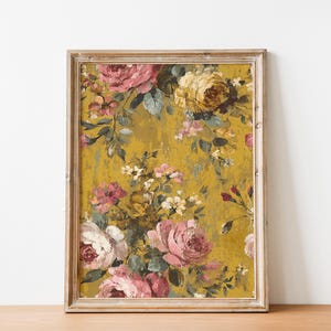May include: A framed floral print featuring a vintage-style design. The artwork showcases a vibrant arrangement of pink, white, and yellow roses against a textured mustard-yellow background. The frame is a light, distressed wood.