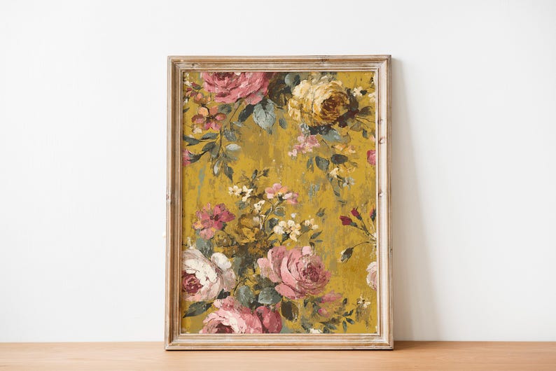 May include: A framed floral print featuring a vintage-style design. The artwork showcases a vibrant arrangement of pink, white, and yellow roses against a textured mustard-yellow background. The frame is a light, distressed wood.