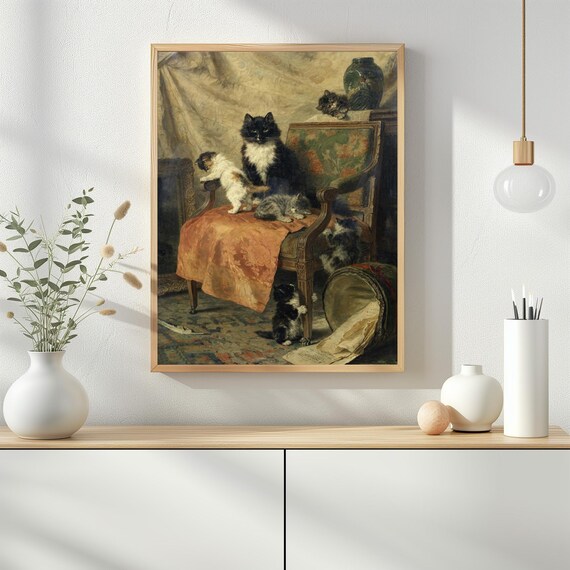 ヴィンテージチェアの上の遊び心のある子猫のアート | 素朴な猫の