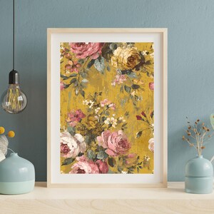 May include: A framed floral print featuring a vintage-style design. The artwork showcases a mustard yellow background with a pattern of pink, white, and yellow roses and other flowers. The frame is a light wood color.