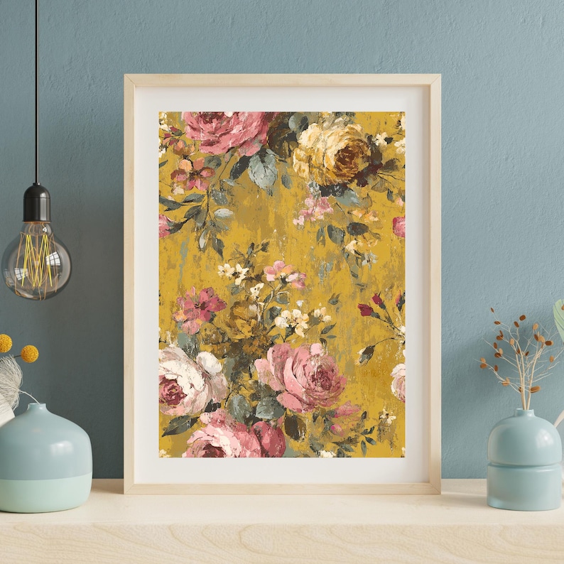 May include: A framed floral print featuring a vintage-style design. The artwork showcases a mustard yellow background with a pattern of pink, white, and yellow roses and other flowers. The frame is a light wood color.