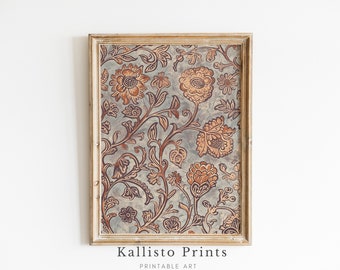 May include: A framed print with a vintage floral pattern in shades of brown and orange on a blue background. The frame is a light wood color.