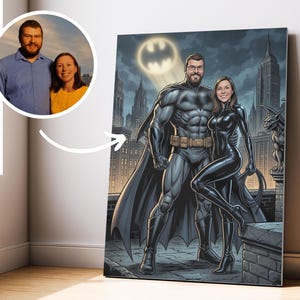 May include: A canvas print showing a couple as Batman and Catwoman, with a cityscape and Bat-Signal in the background. A smaller inset photo displays the couple in everyday clothes. The artwork is a personalised portrait.