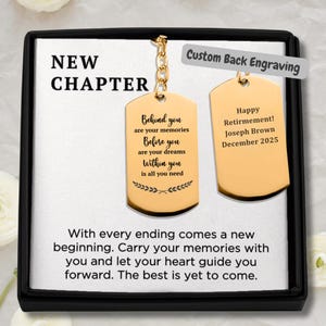 May include: A gold-colored dog tag keychain with the words "New Chapter" at the top. One tag has an inspirational quote, the other says "Happy Retirement!" and the name Joseph Brown, December 2025. The tags are in a black box.