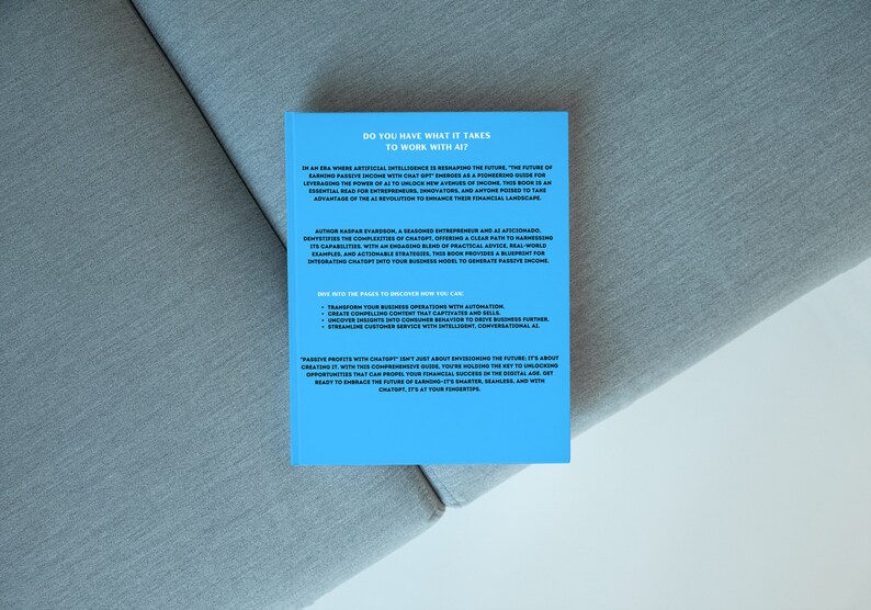 May include: A book with a light blue cover titled "DO YOU HAVE WHAT IT TAKES TO WORK WITH AI?" The book is on a grey surface. The back cover contains text about artificial intelligence and passive income.