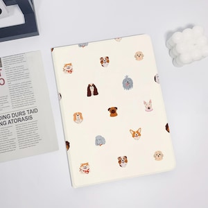 May include: Cream-colored tablet case featuring a repeating pattern of various dog breeds in a cartoon style. The dogs are depicted with different colors and expressions. The case is rectangular and appears to be made of a smooth material.