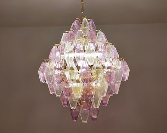 May include: A pink and clear glass chandelier with a gold chain and a gold ceiling mount.