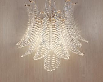 Murano glass wall sconce with clear glass leaves and polished gold metal frame