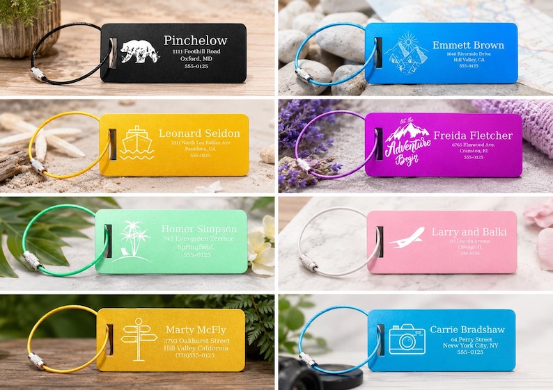 May include: A selection of colourful luggage tags, each with a unique design and name. The tags display images of a bear, mountains, a ship, a mountain with text, palm trees, an airplane, road signs, and a camera. Each tag has a metal loop.