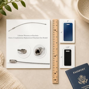 May include: A silver keychain cable with a lifetime warranty, displayed with a ruler and two luggage tags, one blue, 10 cm tall, and one black, 7.6 cm tall. The text reads "Lifetime Warranty on Keychain".