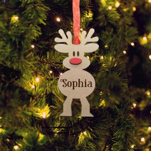 May include: A light-colored wooden reindeer ornament featuring a red nose and the name Sophia engraved in dark brown script lettering. The ornament is suspended by a textured red ribbon and displays a stylized deer shape with antlers.