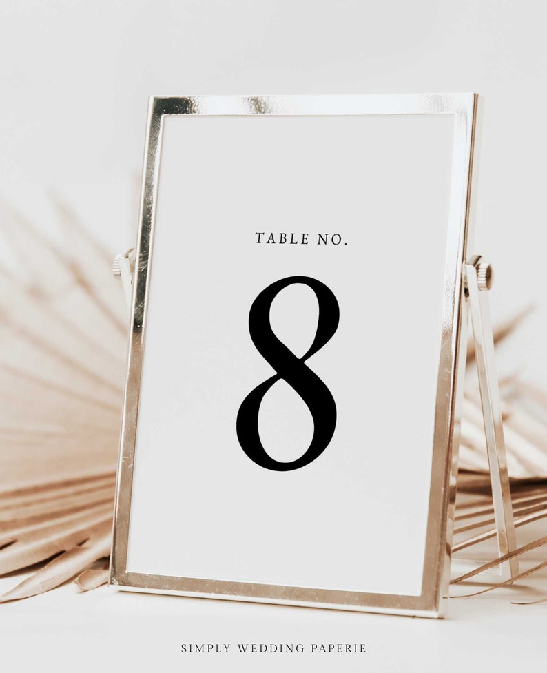 Elegantly guide your guests with our Minimalist Table Number Sign Template by Simply Wedding Paperie. Print and personalize for a stylish touch to your wedding.