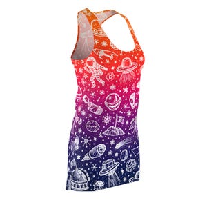 May include: A racerback tank dress featuring a vibrant gradient from orange at the top to deep blue at the bottom. The fabric is covered in a white line-art pattern of space-themed icons including astronauts, UFOs, planets, stars, and rockets.