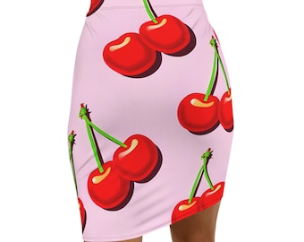 May include: A light pink mini skirt featuring a repeating pattern of bright red cherries with green stems. The cherries have a glossy appearance and are set against a soft pink background. The skirt is form-fitting.