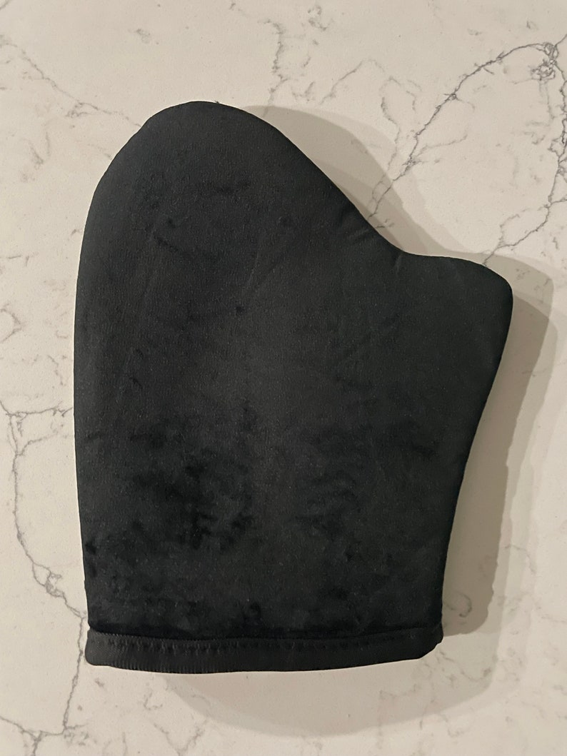 May include: Black self-tanning mitt for applying self-tanner evenly to the skin.