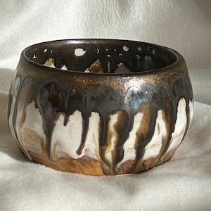 Hand thrown pottery bowl with gold/bronze glaze around the top, which flows down to the soft blush glaze creating unique colour combinations