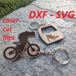 May include: Two laser cut wooden keychains. One keychain is a silhouette of a mountain biker, the other is a cable car with a skier inside. Both keychains are attached to a silver key ring.