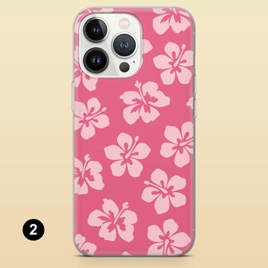 May include: A clear phone case with a pink background and white hibiscus flower pattern. The case is designed for an iPhone.