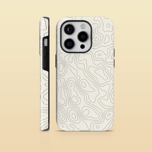 May include: A phone case featuring a topographic map pattern. The case is cream-coloured with black contour lines. The design covers the sides, and the camera lenses are visible.