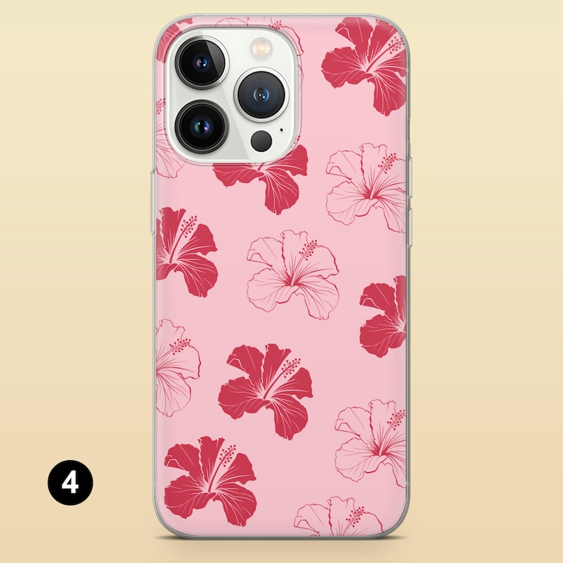 May include: A pink phone case with a clear back and a white border. The case has a pattern of red hibiscus flowers.