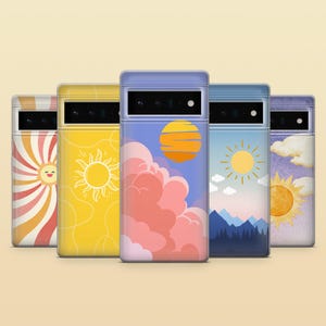 May include: Five smartphone cases arranged in a row, each featuring a unique sun-themed graphic design. The designs include sunburst patterns, line art suns, a sunset with pink clouds, a mountain landscape with a sun, and a sun with clouds.