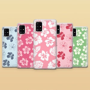 May include: Five different phone cases with a floral pattern. The cases are all clear and have a white floral design on a pink, blue, or green background.