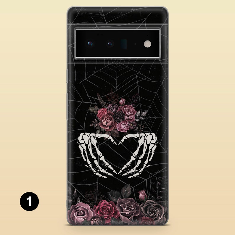 May include: Black phone case with a spiderweb design and a bouquet of pink and purple roses. Two white skeleton hands are forming a heart shape above the roses.