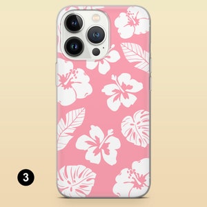 May include: A pink phone case with a white hibiscus flower pattern. The case is designed for an iPhone with a camera bump.