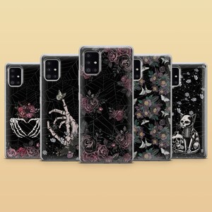 May include: Set of six phone cases with different floral and gothic designs. The cases feature black backgrounds with intricate patterns of flowers, spiderwebs, and skeletons. The designs are in shades of pink, purple, and white.