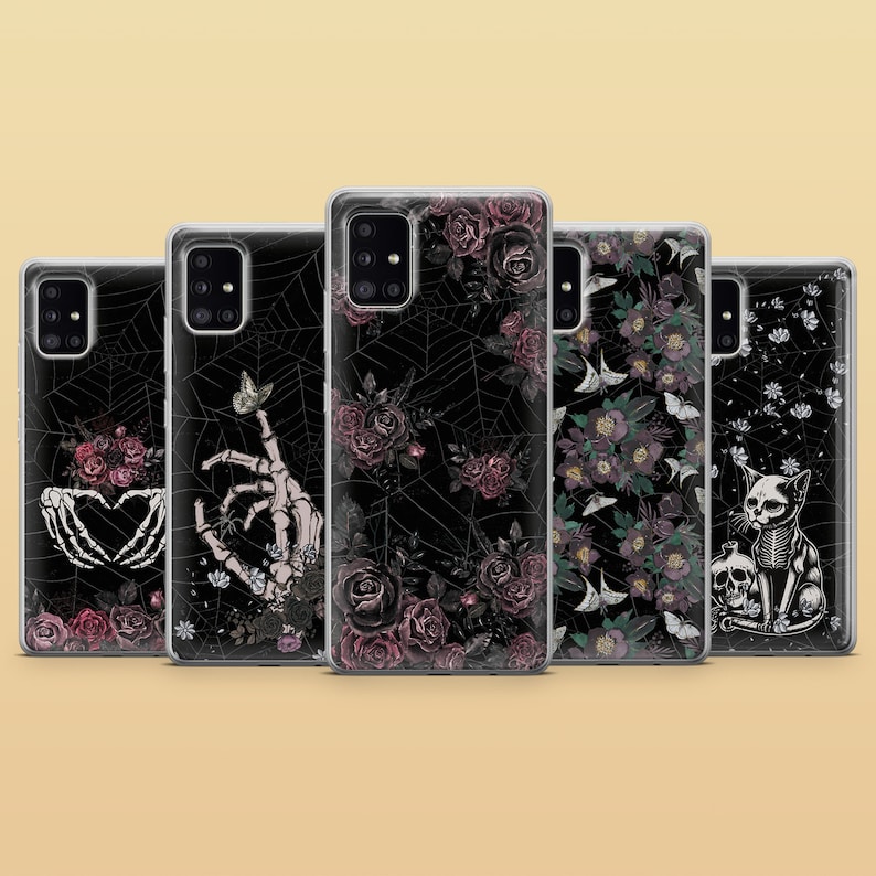 May include: Set of six phone cases with different floral and gothic designs. The cases feature black backgrounds with intricate patterns of flowers, spiderwebs, and skeletons. The designs are in shades of pink, purple, and white.
