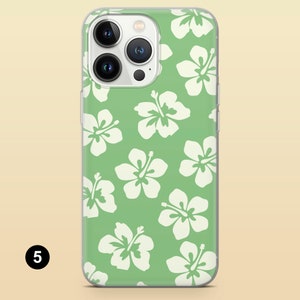 May include: A clear phone case with a green background and white hibiscus flowers. The case is designed for an iPhone 13 Pro Max.