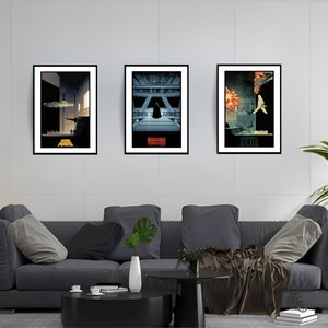 May include: Three framed Star Wars movie posters on a white wall. The posters are in black frames and feature minimalist designs of scenes from the movies. The posters are titled "Star Wars", "The Empire Strikes Back", and "Return of the Jedi".