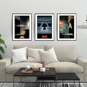 May include: Three framed Star Wars movie posters with minimalist designs. The posters are in black frames and feature the titles "Star Wars", "Empire Strikes Back", and "Return of the Jedi".