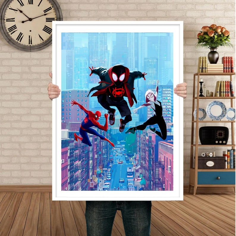 May include: Three Spider-Man characters in red, black, and white costumes are jumping in front of a city skyline. The character in the center is wearing a black and red suit with a red spider logo on the chest. The character on the left is wearing a red and black suit with a red spider logo on the chest. The character on the right is wearing a white and black suit with a white spider logo on the chest.