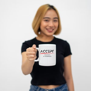 Pode incluir: Uma caneca de cerâmica branca com a palavra ACCEPT em letras maiúsculas pretas e uma linha horizontal vermelha fina por baixo. Abaixo da linha, o texto diz If You Can Read This You're Micromanaging Me numa fonte preta simples sem serifas.