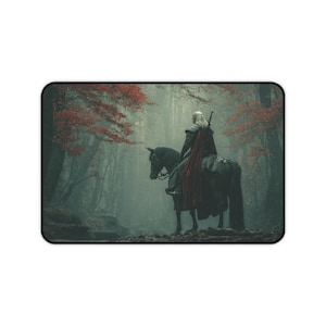 May include: Rectangular mousepad featuring a fantasy scene. A figure in armor with a red cape sits atop a black horse in a misty forest. Red and orange leaves adorn the trees, creating a dramatic contrast against the dark background.