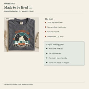 May include: A charcoal gray t-shirt featuring a graphic print of a dog and cat silhouette with the text Fluent in Bark, Meow, and Doctor's Handwriting. The shirt is made of 6.1 oz ring-spun cotton with a relaxed fit and a garment-dyed finish.