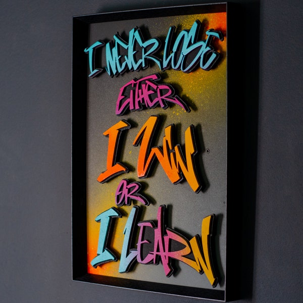 Laser cut quote "Win or Learn" in graffiti style.