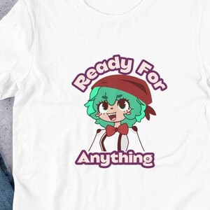 May include: White t-shirt featuring a cartoon anime character with green hair and a red headband. The text "Ready For Anything" is above and below the character in a purple font. The shirt is made of a soft material.