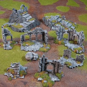 May include: A set of grey stone ruins with arches, walls, and stairs. The ruins are made of a textured material and are designed for tabletop gaming.