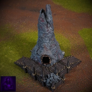 May include: A detailed miniature fantasy structure with a tall, textured, gray and red tower. A wooden dock extends from the base, with a pile of dark gray rocks. The scene is set on a brown and green surface.