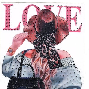 May include: A rhinestone-embellished iron-on patch featuring a woman wearing a brown hat, a gray sweater, and a black backpack. The word "LOVE" is written in pink rhinestones above the woman.