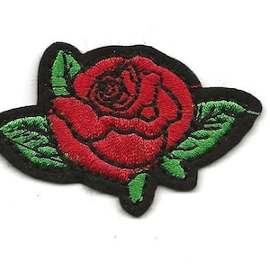 May include: A red embroidered rose with green leaves on a black background.